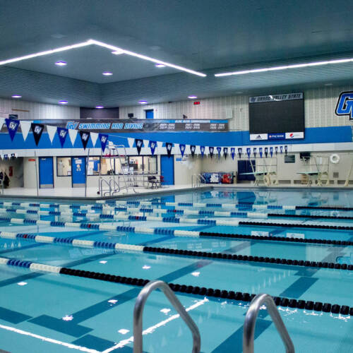 The GVSU Pool, reflecting a light blue color and striped by lane buoys.